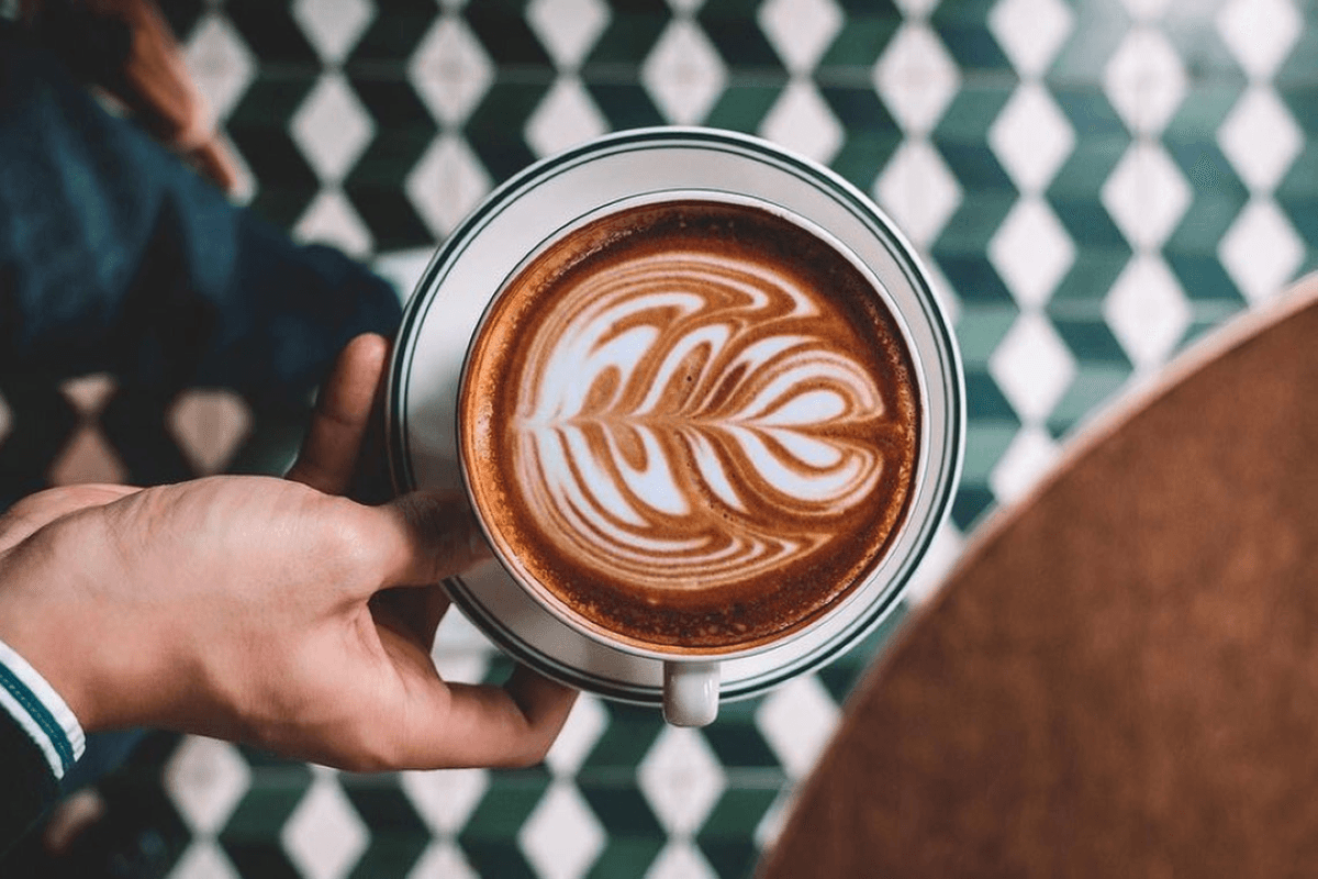 Person holding a cup of coffee